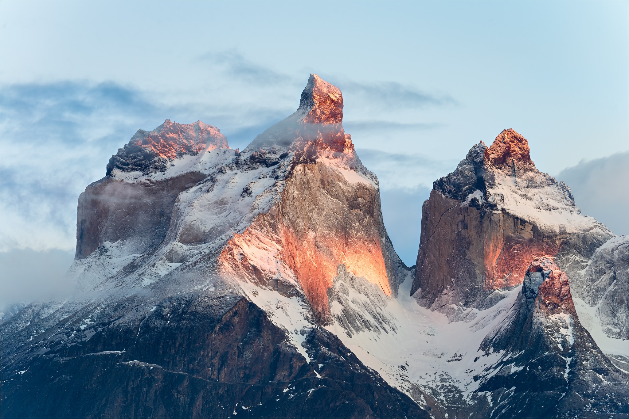 The Cuernos del Paine lit by the red light of dawn